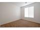 Bedroom showcasing a window, carpet flooring, and neutral paint, offering a serene retreat at 1036 E Magnum Rd, San Tan Valley, AZ 85140
