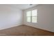 Carpeted bedroom featuring a large window providing plenty of natural light at 1036 E Magnum Rd, San Tan Valley, AZ 85140