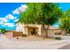 Front exterior of a stucco home with two-car garage and xeriscaped front yard at 1036 E Magnum Rd, San Tan Valley, AZ 85140