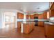 Open kitchen with a center island, stainless steel appliances, and wood look flooring at 1036 E Magnum Rd, San Tan Valley, AZ 85140