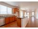 Bright kitchen with wooden cabinets, an island, and a stainless steel dishwasher at 1036 E Magnum Rd, San Tan Valley, AZ 85140