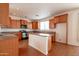 Functional kitchen features wooden cabinets, central island, and stainless steel appliances at 1036 E Magnum Rd, San Tan Valley, AZ 85140