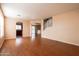 Spacious open-concept living room showcasing wood floors and arched entryways at 1036 E Magnum Rd, San Tan Valley, AZ 85140