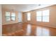 Inviting living room with hardwood floors and abundant natural light from large windows at 1036 E Magnum Rd, San Tan Valley, AZ 85140