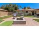 Landscaped backyard featuring a charming patio area with a cozy fire pit and seating at 1170 E Carmen St, Tempe, AZ 85283