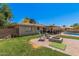 Spacious backyard featuring well-maintained lawn, cozy patio, fire pit, and sparkling pool at 1170 E Carmen St, Tempe, AZ 85283