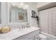 Cozy bathroom featuring a white marble vanity and shower with decorative art pieces at 1170 E Carmen St, Tempe, AZ 85283