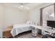 Bright bedroom featuring neutral tones, a ceiling fan, and a comfortable desk area at 1170 E Carmen St, Tempe, AZ 85283