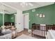 Bedroom featuring a crib, a chair, a ceiling fan, and a mirrored closet door at 1170 E Carmen St, Tempe, AZ 85283