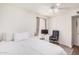 Bright bedroom featuring neutral tones, a ceiling fan, and a comfortable desk area with a sliding closet at 1170 E Carmen St, Tempe, AZ 85283