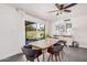 Bright dining area featuring sliding glass doors to the backyard, modern furnishings, and stylish decor at 1170 E Carmen St, Tempe, AZ 85283