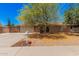 Charming brick home featuring a well-manicured yard and covered entryway, providing instant curb appeal at 1170 E Carmen St, Tempe, AZ 85283
