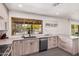 Kitchen with light wood cabinets and a large window overlooking the backyard and pool at 1170 E Carmen St, Tempe, AZ 85283