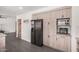 Kitchen featuring stainless steel refrigerator and microwave adjacent to a hallway at 1170 E Carmen St, Tempe, AZ 85283