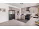 Well-lit kitchen featuring stainless steel appliances, ample cabinets, and gray countertops at 1170 E Carmen St, Tempe, AZ 85283