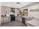 Bright kitchen featuring a large window with backyard views, light cabinets, and stainless steel appliances at 1170 E Carmen St, Tempe, AZ 85283
