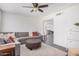 Spacious living room featuring a comfortable sectional sofa, modern ceiling fan, and open access to other areas at 1170 E Carmen St, Tempe, AZ 85283