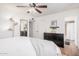 Bedroom with wooden floors, a large dresser, a tall lamp, and access to the bathroom at 1170 E Carmen St, Tempe, AZ 85283
