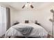 Bright bedroom with a king bed, ceiling fan, a lamp on a bedside table, and natural light at 1170 E Carmen St, Tempe, AZ 85283