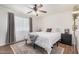 Bedroom featuring a comfortable king bed, a ceiling fan, and modern décor at 1170 E Carmen St, Tempe, AZ 85283