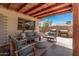 Inviting outdoor patio with comfortable seating, a grill, and an open wood beam ceiling at 1170 E Carmen St, Tempe, AZ 85283
