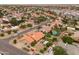 An aerial view of a quiet residential area with green landscaping and terracotta roofs at 12899 W Pasadena Ave, Litchfield Park, AZ 85340
