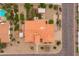 Birds eye of home featuring terracotta roof, lush backyard with grass, and blue pool next door at 12899 W Pasadena Ave, Litchfield Park, AZ 85340
