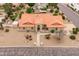 Aerial view of a single-story home with a red tile roof, desert landscaping, and a meticulously designed front yard at 12899 W Pasadena Ave, Litchfield Park, AZ 85340