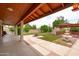 Covered back patio with outdoor space overlooking the backyard, fire pit and fountain at 12899 W Pasadena Ave, Litchfield Park, AZ 85340