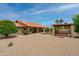Extensive backyard showcasing a covered patio and well-maintained gravel landscaping, creating a relaxing outdoor oasis at 12899 W Pasadena Ave, Litchfield Park, AZ 85340