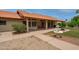 Stunning covered patio with a water fountain and desert landscaping in backyard at 12899 W Pasadena Ave, Litchfield Park, AZ 85340