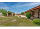 Large backyard featuring a covered patio, gazebo, fountain and mature landscaping at 12899 W Pasadena Ave, Litchfield Park, AZ 85340