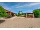Large backyard with a covered patio and mature landscaping, perfect for outdoor gatherings and enjoying the serene surroundings at 12899 W Pasadena Ave, Litchfield Park, AZ 85340
