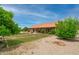 Beautiful backyard with mature trees, covered patio, a gazebo, and a charming fountain at 12899 W Pasadena Ave, Litchfield Park, AZ 85340