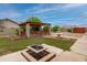 Backyard featuring a covered patio, manicured lawn, and a charming fountain, perfect for enjoying the outdoors at 12899 W Pasadena Ave, Litchfield Park, AZ 85340