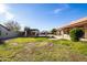 Large backyard featuring covered patio, gazebo, fire pit and water feature at 12899 W Pasadena Ave, Litchfield Park, AZ 85340
