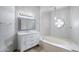 Bathroom featuring a vanity with marble countertop, jacuzzi tub, and stylish fixtures at 12899 W Pasadena Ave, Litchfield Park, AZ 85340