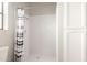 Full bathroom featuring shower with curtain, tile surround and built-in storage at 12899 W Pasadena Ave, Litchfield Park, AZ 85340