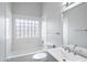 Well-lit bathroom features tiled shower/tub and modern vanity with a large mirror at 12899 W Pasadena Ave, Litchfield Park, AZ 85340