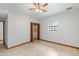 Neutral bedroom features tile floors, natural light and closet for storing clothes and accessories at 12899 W Pasadena Ave, Litchfield Park, AZ 85340
