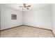 Bright bedroom featuring neutral walls, ceiling fan and tile flooring at 12899 W Pasadena Ave, Litchfield Park, AZ 85340