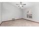 Clean bedroom design with tile flooring, a ceiling fan, and a shuttered window at 12899 W Pasadena Ave, Litchfield Park, AZ 85340