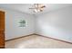 Neutral bedroom with wood trim, tile floor, window and closet for storing clothes and accessories at 12899 W Pasadena Ave, Litchfield Park, AZ 85340