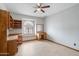 Spacious bedroom features a built in vanity, tile floors and arched window that offers natural light at 12899 W Pasadena Ave, Litchfield Park, AZ 85340