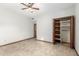 Spacious bedroom features tile floors, ceiling fan and closet with bifold doors at 12899 W Pasadena Ave, Litchfield Park, AZ 85340