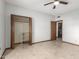 Bedroom with tile floors and an open closet leads to a laundry room at 12899 W Pasadena Ave, Litchfield Park, AZ 85340