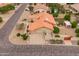 A one-story home features desert landscaping, a terracotta roof, and a spacious three-car garage at 12899 W Pasadena Ave, Litchfield Park, AZ 85340