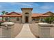 Charming single-story home with terra cotta roof, arched windows, desert landscaping, and decorative post boxes at 12899 W Pasadena Ave, Litchfield Park, AZ 85340