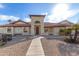 Inviting home featuring a well-manicured yard, tiled roof, and a charming arched entryway at 12899 W Pasadena Ave, Litchfield Park, AZ 85340