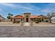 Charming single-story home with a red tile roof, arched windows, and meticulously landscaped front yard at 12899 W Pasadena Ave, Litchfield Park, AZ 85340